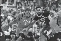  ?? Canadian Press photo ?? Toronto Raptors forward Kawhi Leonard (2) moves pass Philadelph­ia 76ers forward Wilson Chandler during first half NBA basketball action in Toronto on Wednesday.