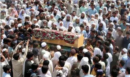  ?? Photograph: Mohammad Sajjad/AP ?? Relatives and mourners carry the casket of a victim killed in Sunday's suicide bombing in Khyber Pakhtunkhw­a, Pakistan.
