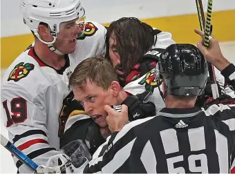  ?? MATT STONE / HERALD STAFF ?? ROUGH STUFF: Jonathan Toews, left, of the Chicago Blackhawks holds back Brad Marchand of the Bruins as he tries to fight with Connor Murphy during the second period of the NHL game against the Chicago Blackhawks at the TD Garden.