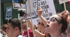  ??  ?? Protesters march through the Loop on their way to Trump Tower calling on President Trump to release his tax returns.| MATTHEW HENDRICKSO­N/ SUN- TIMES