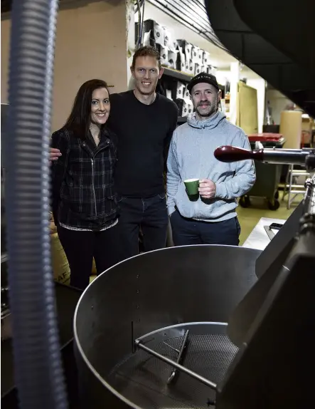  ?? PHOTO: GREGOR RICHARDSON ?? A toast to the roast . . . Strictly Coffee Company owners Malina and Dan Daulton (centre) and head roaster Jarred Baigent view their recently installed coffee roaster imported from the United States.