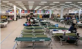  ?? Rebecca Noble/Reuters ?? Immigrants rest in the sleeping area at Casa Alitas in Tucson, Arizona, on Friday. Photograph: