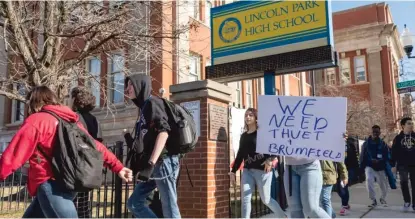  ?? ASHLEE REZIN GARCIA/SUN-TIMES ?? Students march during a walkout Monday to protest Chicago Public Schools’ decision to remove interim principal John Thuet and assistant principal Michelle Brumfield and to cancel the remainder of the boys basketball season.