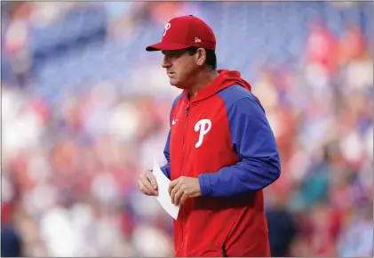  ?? MATT SLOCUM — THE ASSOCIATED PRESS ?? Phillies interim manager Rob Thomson walks to exchange line ups before his first game in charge against the Angels on Friday night.