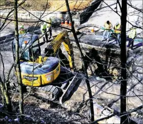  ?? Nate Guidry/Post-Gazette ?? Crews are working along Parker Street in Etna on Monday to repair a leak between the Lanpher reservoir and the Aspinwall treatment plant.