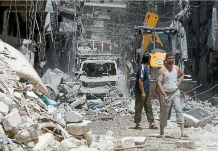  ?? PHOTO: REUTERS ?? Residents inspect the damage after an air strike on Aleppo’s rebel held al-Mashad neighbourh­ood.