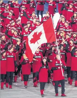  ?? THE CANADIAN PRESS/PAUL CHIASSON ?? Ice dancers Tessa Virtue and Scott Moir lead the Canadian team into the stadium during the opening ceremony at the 2018 Winter Olympic Games in Pyeongchan­g, South Korea, Friday,