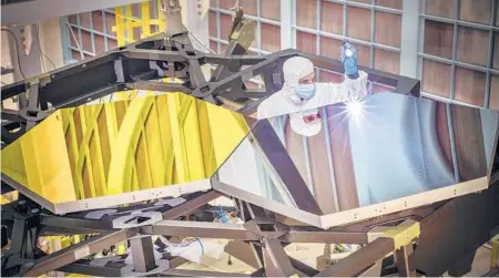  ?? NASA 2014 ?? An optical engineer works on a prototype of the James Webb Space Telescope at the Goddard Space Flight Center’s clean room in Greenbelt, Md.