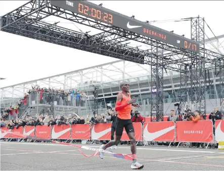  ?? LUCA BRUNO/THE ASSOCIATED PRESS ?? Olympic marathon champion Eliud Kipchoge crosses the finish line at the Monza Formula One racetrack in Italy earlier this month with a time of two hours and 25 seconds. Nike is leading a push for a two-hour marathon.