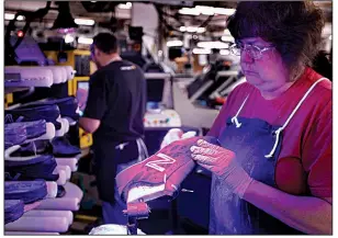  ?? AP/ROBERT F. BUKATY ?? A worker assembles athletic shoes at a New Balance factory in Norridgewo­ck, Maine. U.S. factory production contracted in January, mostly because of weakness in the automotive sector.