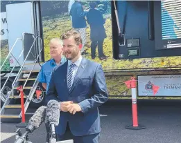  ?? ?? Police, Fire and Emergency Management Minister Felix Ellis and TFS chief officer Dermot Barry outside the MILE truck.