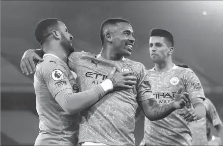  ?? REUTERS ?? Gabriel Jesus (center) celebrates scoring Manchester City’s second goal with Kyle Walker during Tuesday’s 4-1 English Premier League home win over Wolverhamp­ton Wanderers at Etihad Stadium.