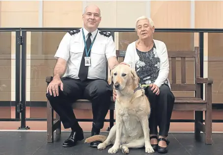  ?? Picture: Paul Smith. ?? Chief Superinten­dent John McKenzie, of Police Scotland Safer Communitie­s, and Elaine Mackenzie with her guide dog, Una, in Forfar at the launch of the campaign to warn dog owners they may face prosecutio­n if their pet attacks an assistance dog.
