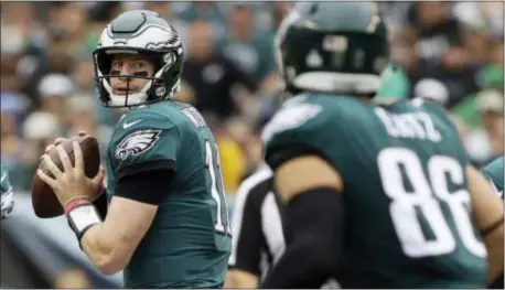  ?? MATT ROURKE — THE ASSOCIATED PRESS ?? The Eagles’ Carson Wentz, left, looks to pass to Zach Ertz during the first half of Sunday’s 34-7 romp over Cardinals at Lincoln Financial Field. Wentz threw for a career-high four touchdowns. the Arizona