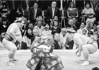  ?? EVAN VUCCI
THE ASSOCIATED PRESS ?? U.S. President Donald Trump, seated centre, top, attends the Tokyo Grand Sumo Tournament with Japanese Prime Minister Shinzo Abe, left, on Sunday. At top right is Akie Abe, seated beside Melania Trump.