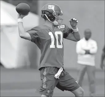  ?? JULIO CORTEZ/AP PHOTO ?? The Giants’ Eli Manning throws a pass during Saturday’s training camp in East Rutherford, N.J. The Giants play host to the Pittsburgh Steelers on Friday in the first preseason game for both teams