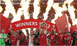  ?? ?? Jordan Henderson lifts the trophy as Liverpool celebrate winning the FA Cup final against Chelsea.