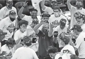  ?? TONY DEJAK/AP ?? Ohio coach Jeff Boals celebrates with his players after the Bobcats beat Buffalo last Saturday in the final of the Mid-american Conference tournament to qualify for the NCAA field for the first time since 2012.