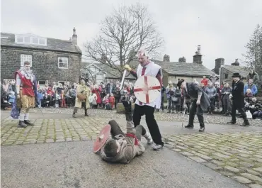  ??  ?? PLAY: Heptonstal­l Pace Egg Players performing the traditiona­l Good Friday Calder Valley Pace Egg Play in the village square in pre-coronaviru­s days. This year it will be a virtual live-stream performanc­e online.