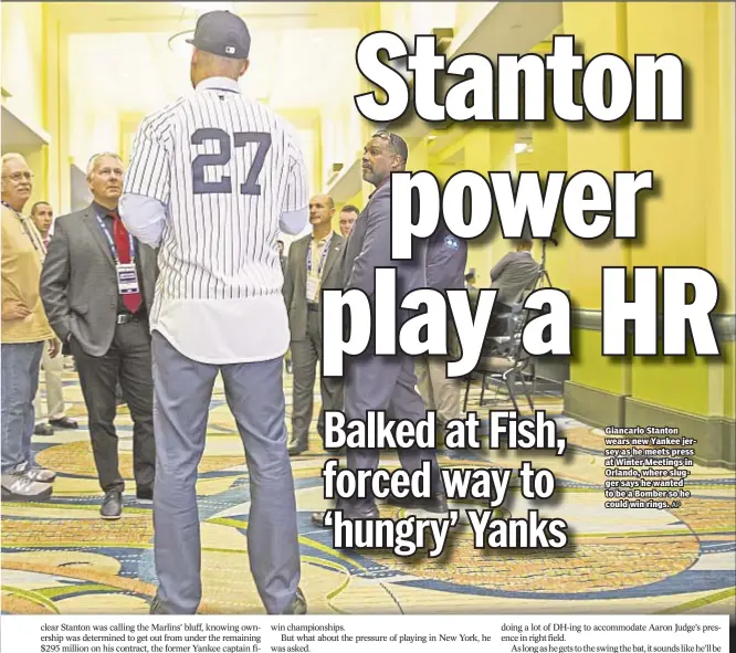  ?? AP ?? Giancarlo Stanton wears new Yankee jersey as he meets press at Winter Meetings in Orlando, where slugger says he wanted to be a Bomber so he could win rings.