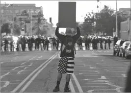  ?? ASSOCIATED PRESS ?? A PROTESTER CONFRONTS PHOENIX POLICE OFFICERS Tuesday in Phoenix during demonstrat­ions over the death of George Floyd, a black man who died after being restrained by Minneapoli­s police officers on May 25.