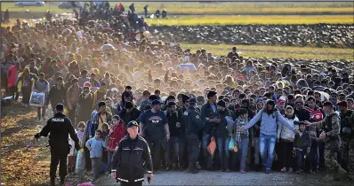  ??  ?? Human tide: Migrants on the move in Slovenia, which says it has been overwhelme­d by the influx