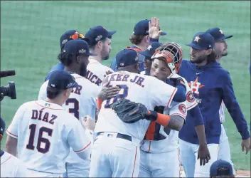  ?? Karen Warren / Houston Chronicle ?? Astros catcher Martin Maldonado ( 15) gets a hug from manager Dusty Baker as they celebrate winning Game 4 of the ALDS against the Athletics on Thursday.