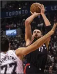  ?? CP PHOTO / CHRIS YOUNG ?? Toronto Raptors centre Jonas Valanciuna­s (17) shoots over San Antonio Spurs centre Joffrey Lauvergne (77) during second half NBA basketball action in Toronto on Friday.