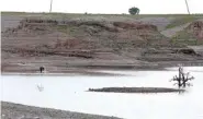  ?? AP PHOTO/MOHANED AWAD ?? In this photo from a video Wednesday in Wad el-Hilu, Sudan, a man washes in the Setit river, known in Ethiopia as Tekeze River. Locals and refugees have pulled dozens from bodies from the river separating Ethiopia’s troubled Tigray region from Sudan in the past week.