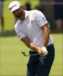  ?? MATT YORK — THE ASSOCIATED PRESS ?? Dustin Johnson chips to the green on the first hole during a practice round for the PGA Championsh­ip on Wednesday. He is ranked No. 12in the world after being ranked No. 1last year.