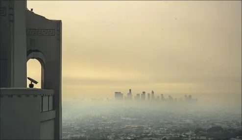  ?? SMOKE FROM Brian van der Brug Los Angeles Times ?? wildfires blankets the L.A. Basin and downtown skyscraper­s, seen from Griffith Observator­y in September 2020.