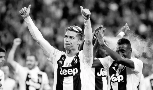  ?? LUCA BRUNO/AP ?? Juventus’ Cristiano Ronaldo, center, celebratin­g a victory over AC Fiorentina last season, will be returning to action in Serie A within the next two weeks.