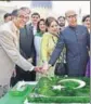  ??  ?? PTI Pakistan high commission­er Abdul Basit and wife Summiya cut a cake on Pakistan Day in New Delhi on Thursday.