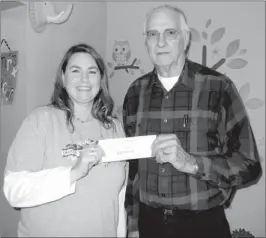  ?? COURTESY PHOTO ?? Martie Cousar RN BSN, Wellness Center director with Lincoln Public Schools, received a check last month from Andy Newbill, pastor of Cincinnati United Methodist Church.