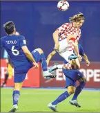  ??  ?? Croatia's Luka Modric (C) vies with Greece's Alexandros Tziolis (L) and Zeca in Zagreb.