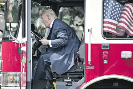  ?? ANDREW HARRER/BLOOMBERG ?? U.S. President Donald Trump sits in a fire truck during a White House media event on Monday. The U.S. government released a 16-page list of goals for NAFTA renegotiat­ion, some elements of which appear contradict­ory or confusing.
