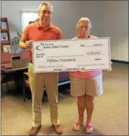  ?? SUBMITTED PHOTO ?? Brian Parkes (left), executive director of the TriCounty Active Adult Center, and Barbara Updegrove, a volunteer and participan­t at the Center, display the check that will be presented to one lucky winner at the conclusion of the 20th annual raffle.