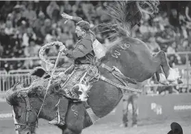  ?? Yi-Chin Lee / Staff photograph­er ?? Rusty Wright, representi­ng San Angelo, scores an 88 on Wild Cherry to win in saddle bronc during the one-day Super Shootout on Saturday at NRG Stadium.