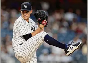  ?? Adam Hunger / Associated Press ?? New York pitcher Andrew Heaney winds up during the first inning of the team's baseball game against the Boston Red Sox on Wednesday. Heaney pitched seven innings and struck out four, allowing one run.