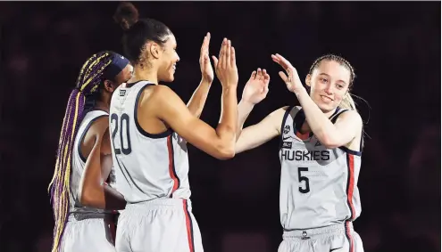  ?? Elsa / Getty Images ?? UConn’s Paige Bueckers, right, is introduced before the national semifinal game against Arizona on April 2 in San Antonio.