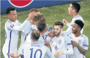  ??  ?? NEARLY ALL WHITE ON THE NIGHT: England players celebrate Eric Dier’s strike