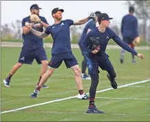  ??  ?? Atlanta Braves pitchers Shane Greene (from left), Mike Foltynewic­z and Max Fried loosen up at spring training in North Port, Fla.