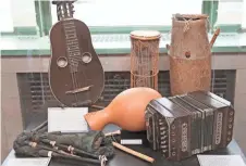  ??  ?? The exhibit includes a zither-mandolin hybrid (counter-clockwise from upper left), bagpipes, a bandoneon and African drums.