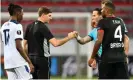  ??  ?? The Rangers head coach Steven Gerrard (left) bumps knuckles with the referee Danny Makkelie after their Europa League loss at the BayArena. Photograph: Martin Meissner/PA