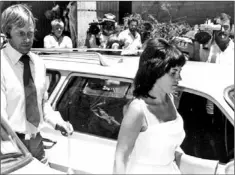  ?? — Associated Press file photo ?? In this Feb. 2, 1982, file photo, Michael (left) and Lindy Chamberlai­n leave a courthouse in Alice Springs, Australia. A coroner found Tuesday a dingo took the Chamberlai­ns’ baby who vanished in the Australian Outback more than 32 years ago in a...