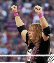  ??  ?? FILE - In this March 28, 2010, file photo, Bret “Hit Man” Hart celebrates his victory over Mr. McMahon at WrestleMan­ia XXVI in Glendale, Ariz. Hart was one of the biggest wrestling stars of all time.