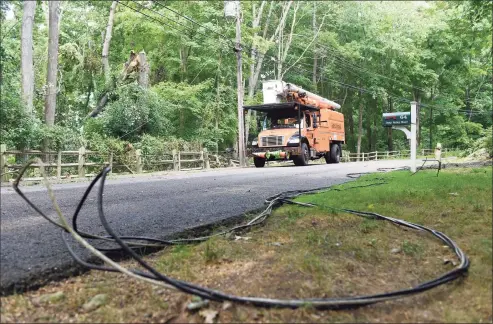  ?? Tyler Sizemore / Hearst Connecticu­t Media file photo ?? Crews examine downed trees and power lines knocked down during Tropical Storm Isaias on Deep Valley Road in North Stamford on Aug. 12, 2020.