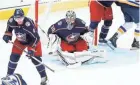  ?? ADAM CAIRNS/COLUMBUS DISPATCH ?? Goaltender Jean-francois Berube, here watching the puck, received a call-up to the Blue Jackets after Elvis Merzlikins and Daniil Tarasov suffered lower-body injuries.