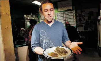  ?? Chad Hipolito/THE CANADIAN PRESS ?? Owen Smith, at the Cannabis Buyers Club in Victoria, B.C., poses with a plate of marijuana in various forms after he was vindicated Thursday by the Supreme Court of Canada.