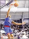  ?? (AP) ?? Kansas guard Ochai Agbaji (30) dunks the ball over TCU’s Alex Robinson (bottom right), in the first half of an NCAA college basketball game in Fort Worth, Texas on Feb11.